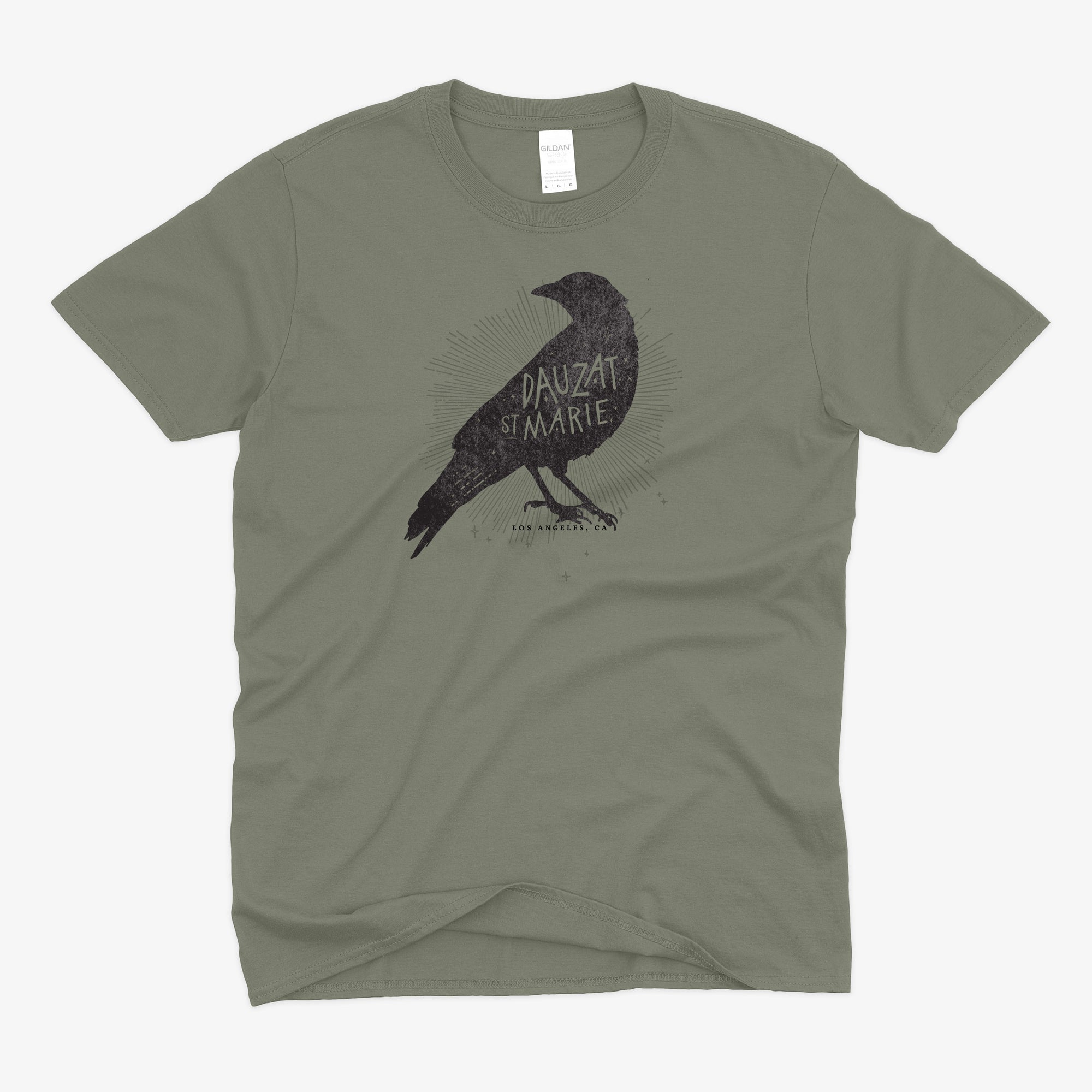 A heather olive green short-sleeve t-shirt with a distressed black graphic of a raven and the text 'DAUZAT ST. MARIE"